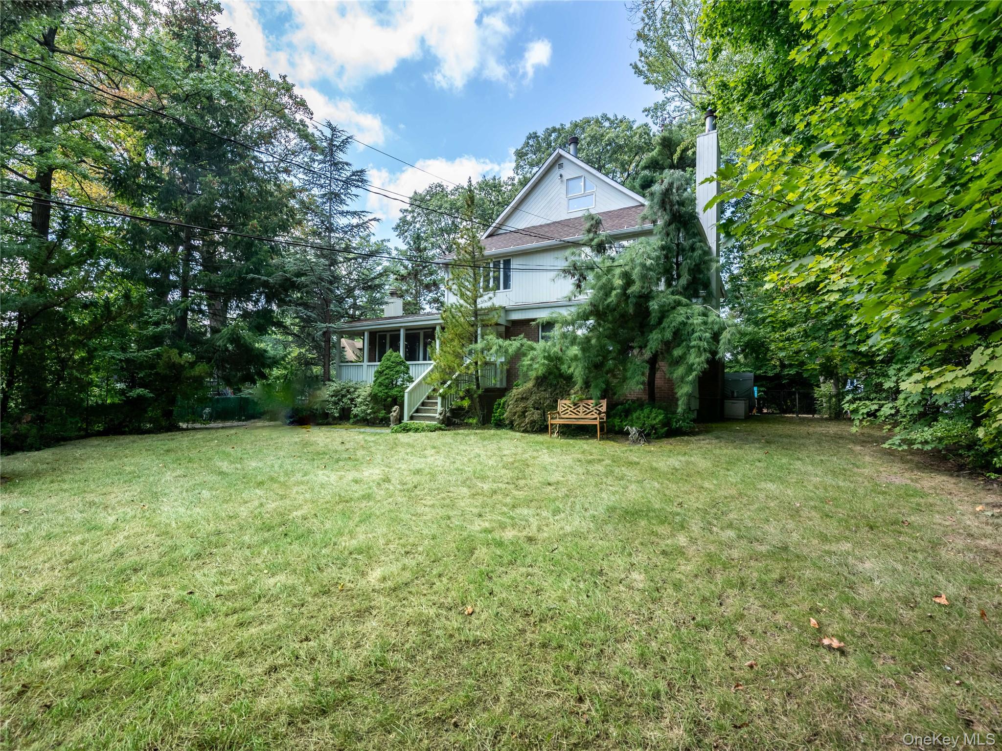 100 Station Road Great Neck, NY 11023 - Photo 24 of 29 a view of a house with a yard