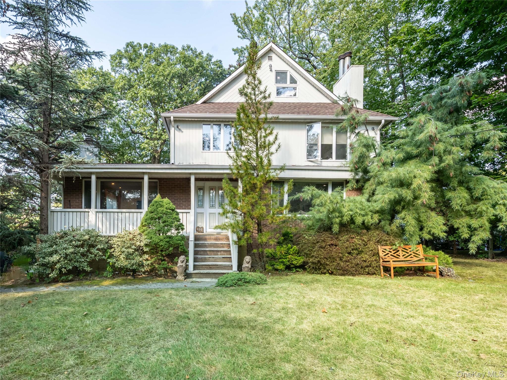 100 Station Road Great Neck, NY 11023 - Photo 29 of 29 a front view of a house with a yard