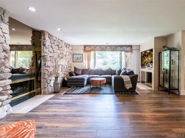 a living room with furniture window and a fireplace