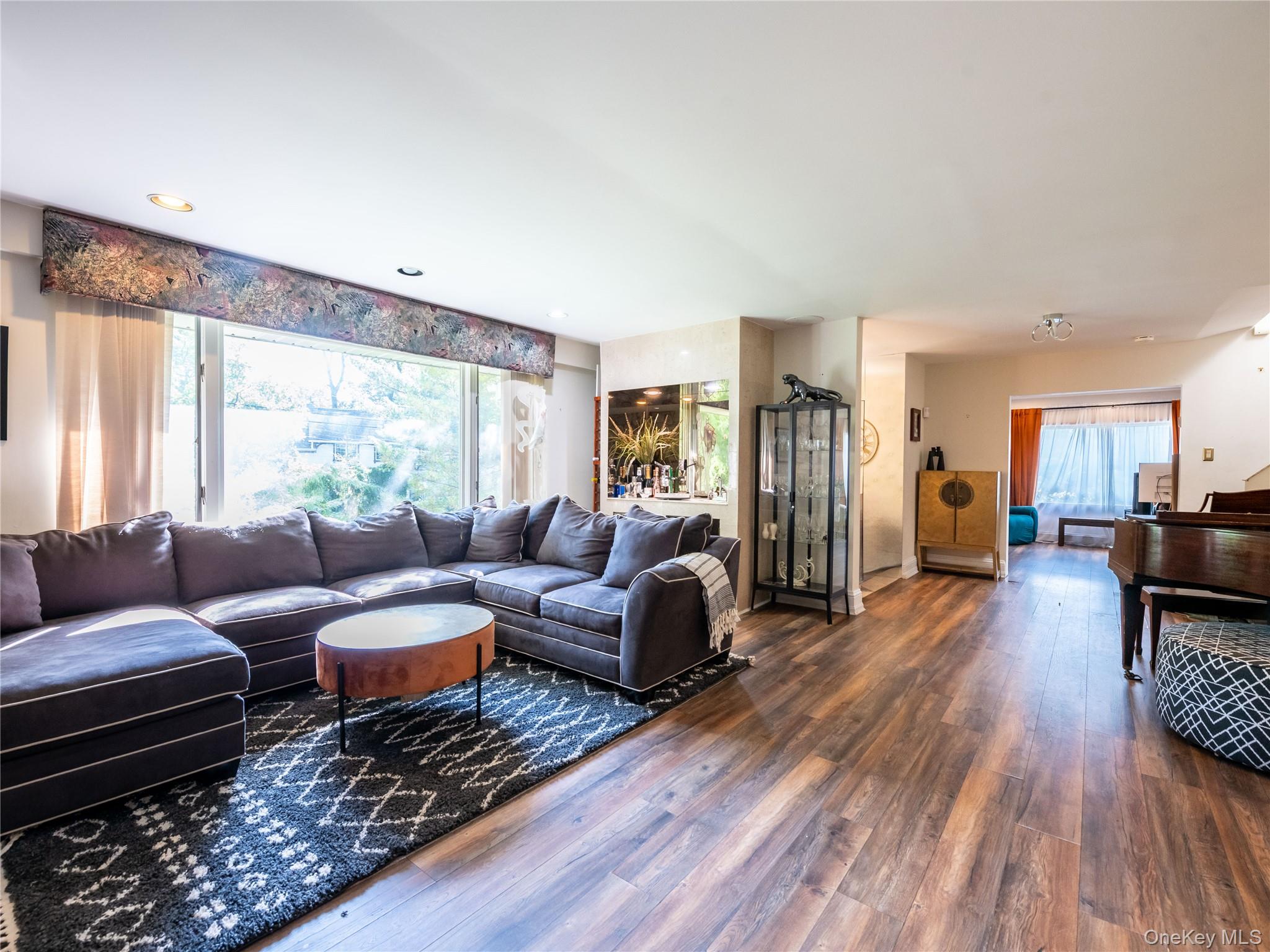100 Station Road Great Neck, NY 11023 - Photo 7 of 29 a living room with furniture and a wooden floor