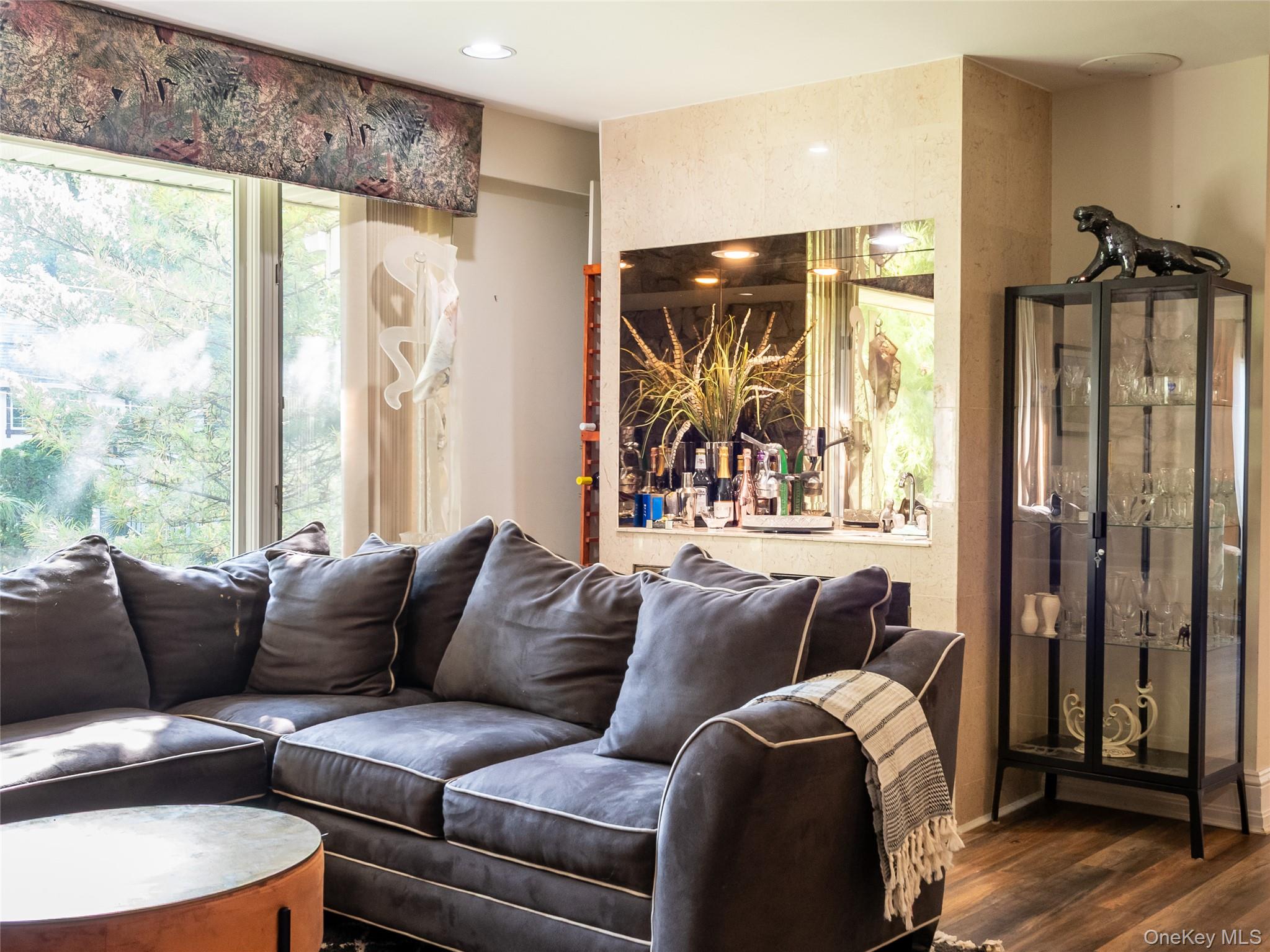 100 Station Road Great Neck, NY 11023 - Photo 9 of 29 a living room with furniture and a large window