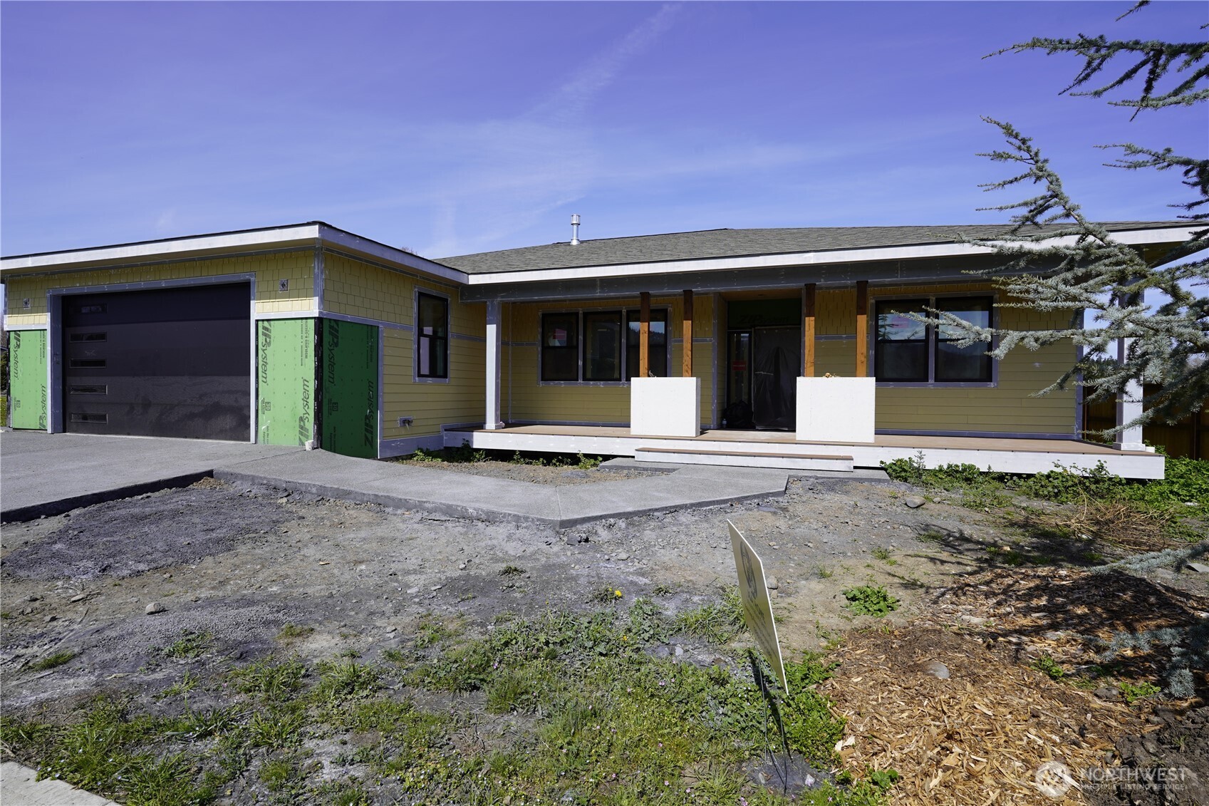 61 Berkshire Street Sequim, WA 98382 - Photo 2 of 2 a front view of a house with a yard and garage