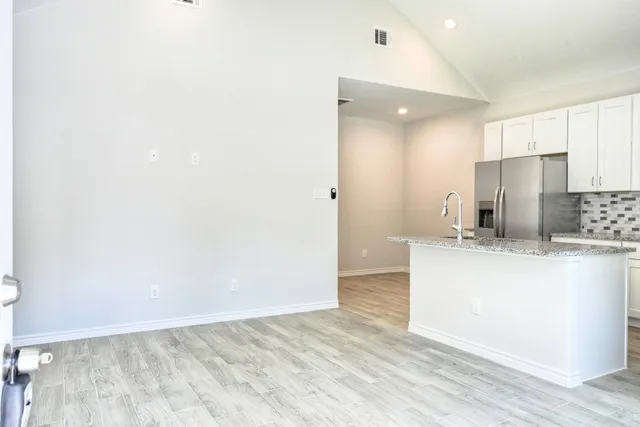 a view of kitchen with refrigerator sink and wooden floor