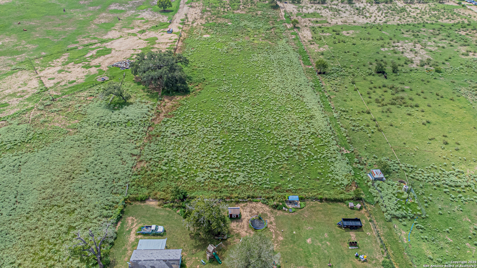 146 County Road 166 Elmendorf, TX 78112 - Photo 5 of 14 a view of a green yard