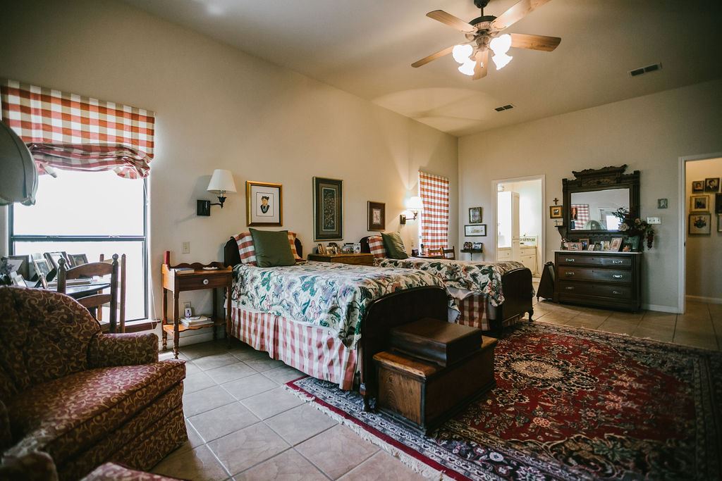 375 Co Road Uvalde, TX 78801 - Photo 25 of 30 a bedroom with a bed a couch and dresser