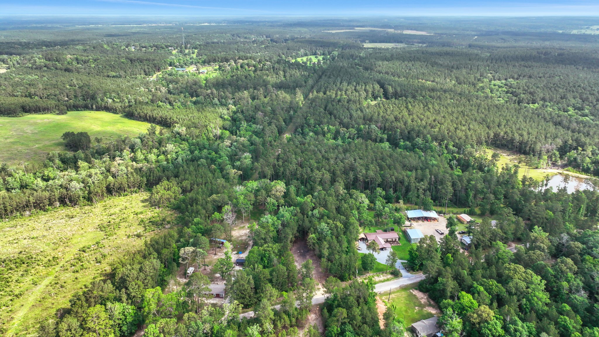 Tbd Sugar Hill Road Livingston, TX 77351 - Photo 11 of 12 Distant aerial shot captures the full expanse of the surrounding countryside - rolling terrain, open pasture, and thick tree lines create a postcard-worthy backdrop for this hidden gem in the heart of East Texas.