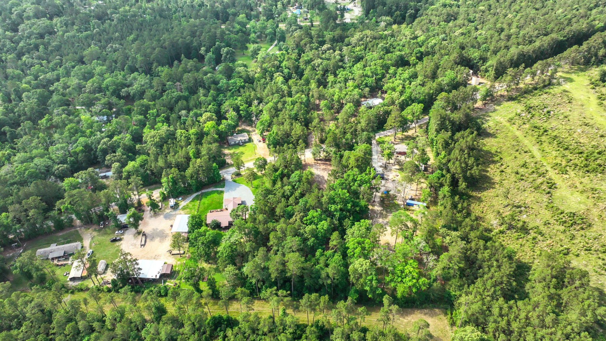 Tbd Sugar Hill Road Livingston, TX 77351 - Photo 9 of 12 Bird’s-eye view captures the natural beauty and privacy this property offers. Surrounded by dense trees with neighboring homes spaced generously apart, this parcel blends the best of country living with a sense of seclusion and space to grow.