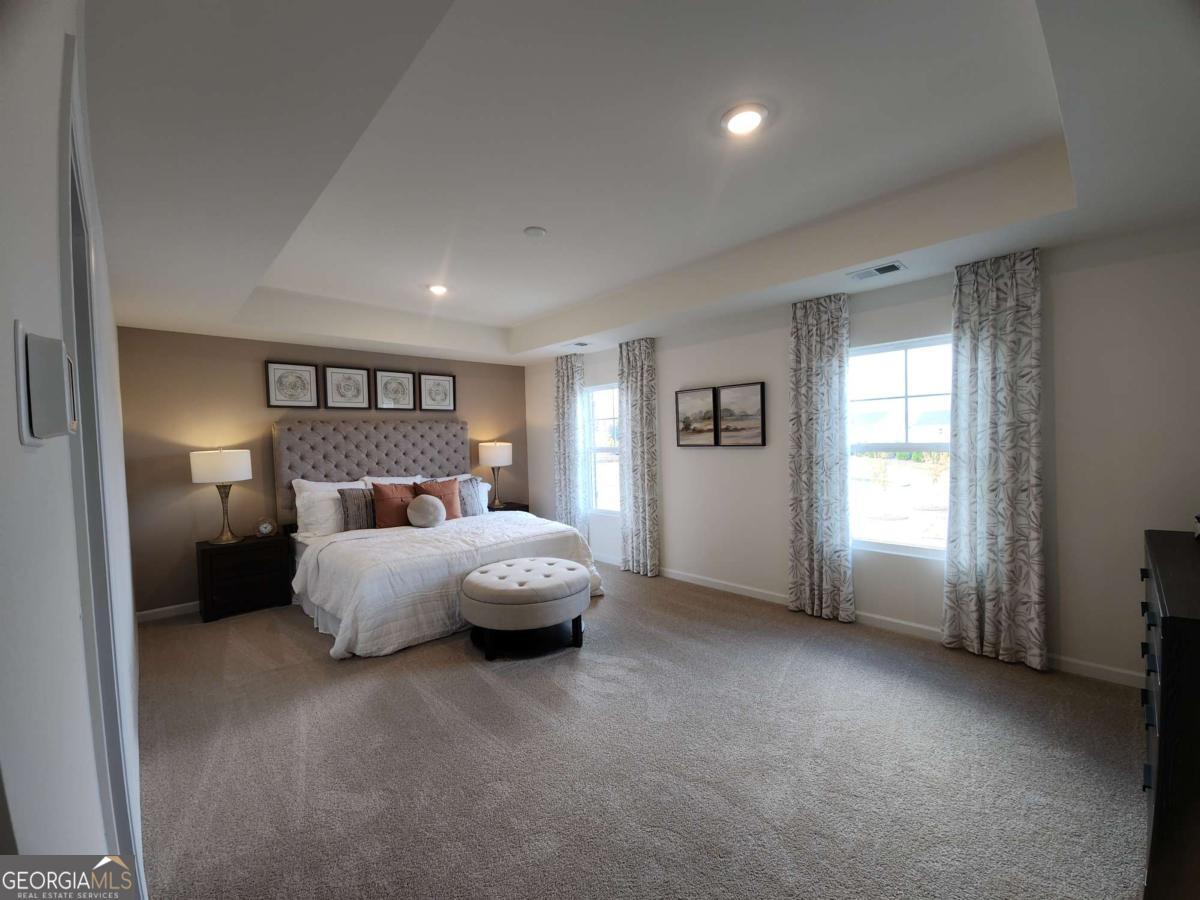 191 Aster Avenue Locust Grove, GA 30248 - Photo 14 of 28 a bed room with a bed and a couch