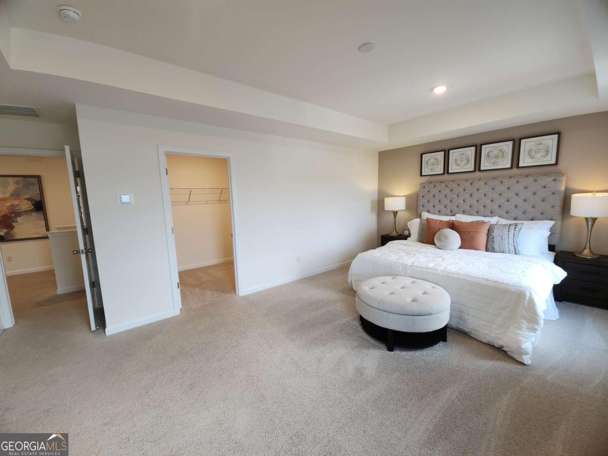 191 Aster Avenue Locust Grove, GA 30248 - Photo 15 of 28 a bedroom with a bed and a night stand