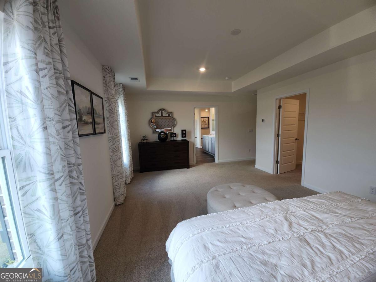 191 Aster Avenue Locust Grove, GA 30248 - Photo 16 of 28 a bedroom with a bed and dresser