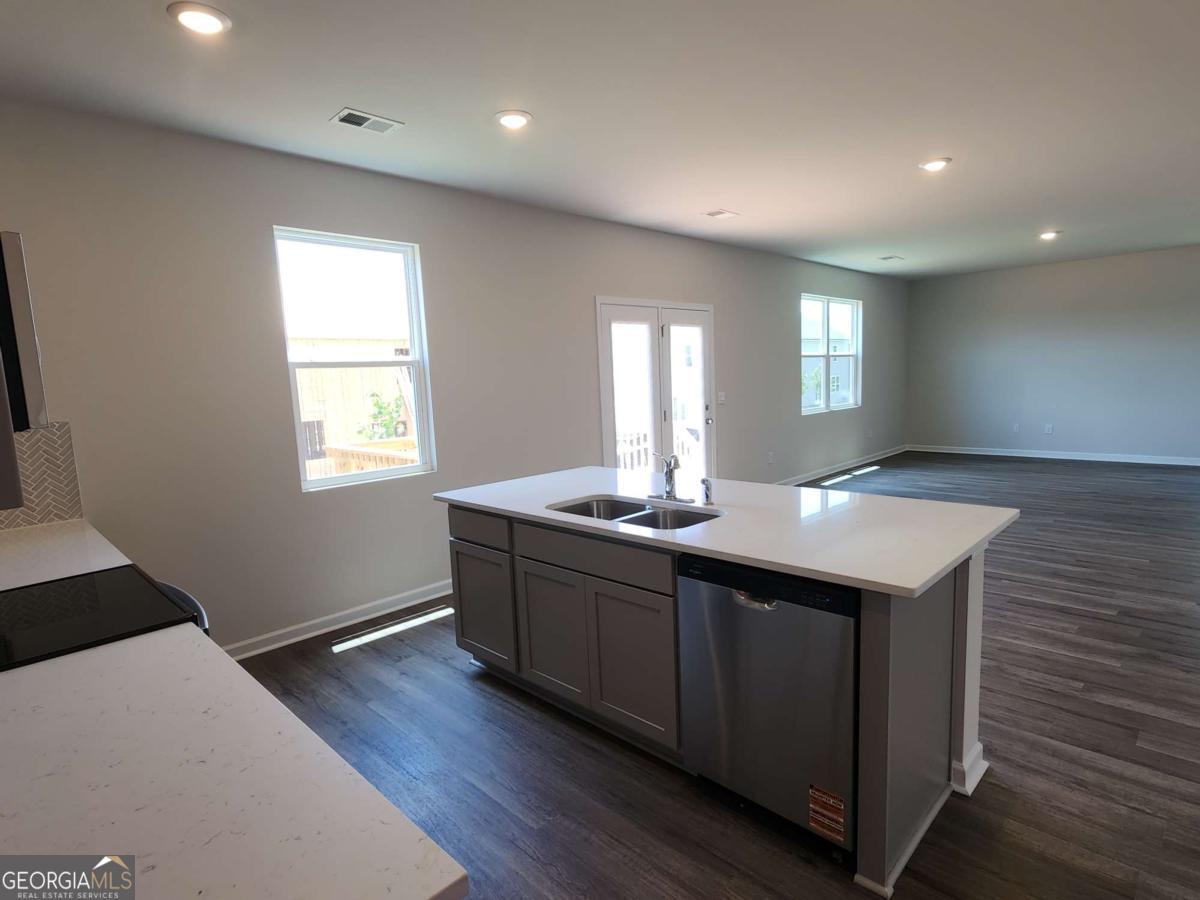 191 Aster Avenue Locust Grove, GA 30248 - Photo 19 of 28 a room with a sink wooden floor and a window