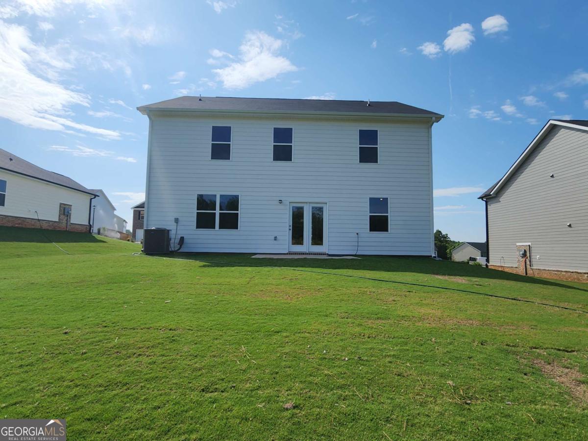 191 Aster Avenue Locust Grove, GA 30248 - Photo 2 of 28 a view of a house with a backyard