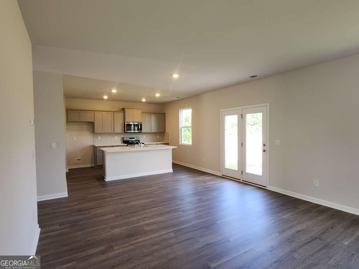 191 Aster Avenue Locust Grove, GA 30248 - Photo 21 of 28 a view of kitchen with wooden floor and windows