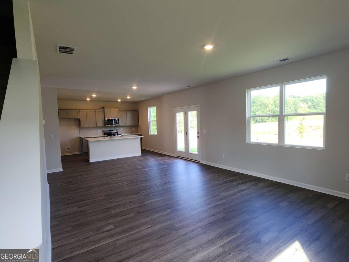 191 Aster Avenue Locust Grove, GA 30248 - Photo 22 of 28 a view of a kitchen with a sink and a stove top oven