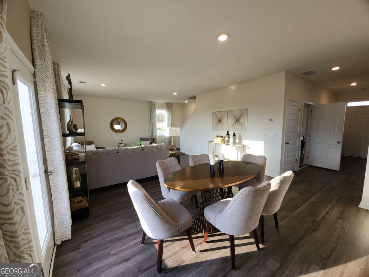 191 Aster Avenue Locust Grove, GA 30248 - Photo 10 of 28 a view of a dining room with furniture and wooden floor