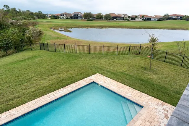 an aerial view of residential houses with outdoor space and swimming pool