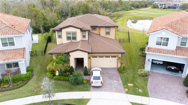 a front view of a house with a garden and yard