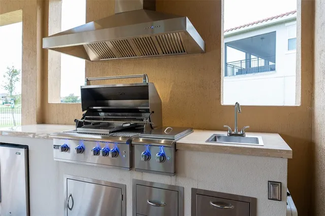 a large kitchen with a table and chairs