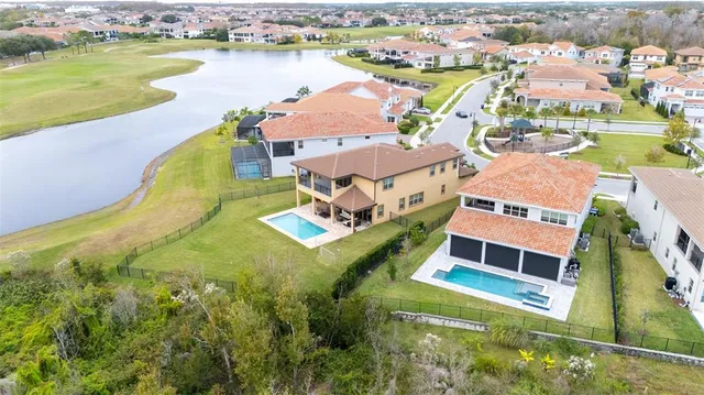 a kitchen with stainless steel appliances granite countertop a sink and a refrigerator