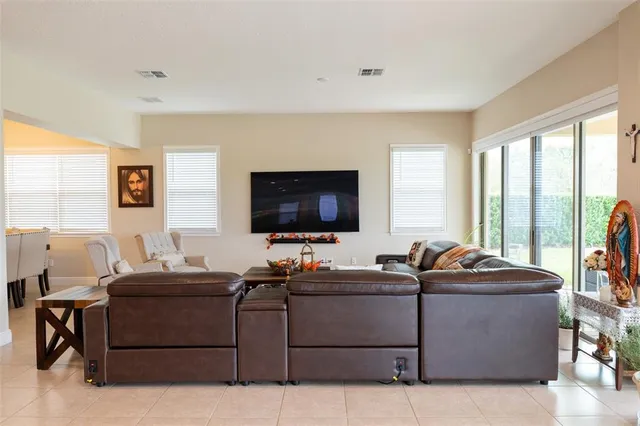 a living room with fireplace furniture and a flat screen tv