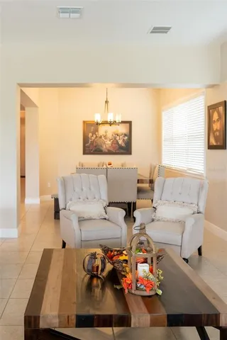 a view of a workspace with furniture and a bookshelf