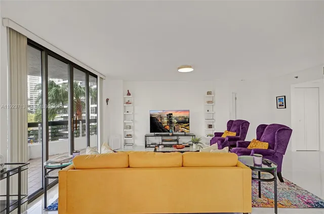 a bedroom with a bed a window and a flat screen tv