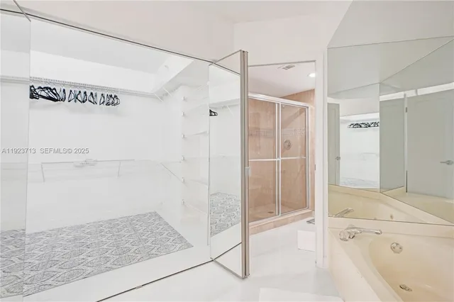 a bathroom with a shower and a bath tub