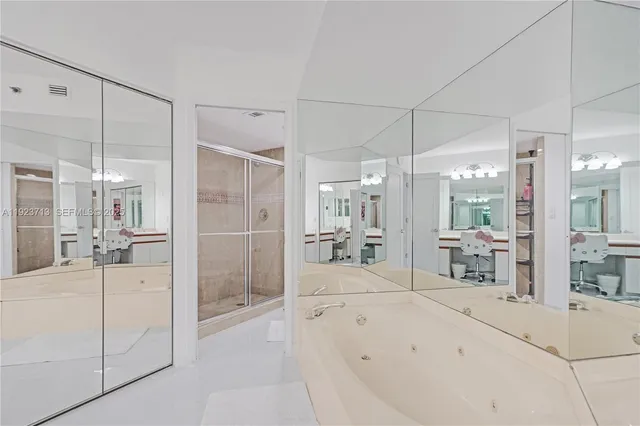 a large bathroom with a glass shower door