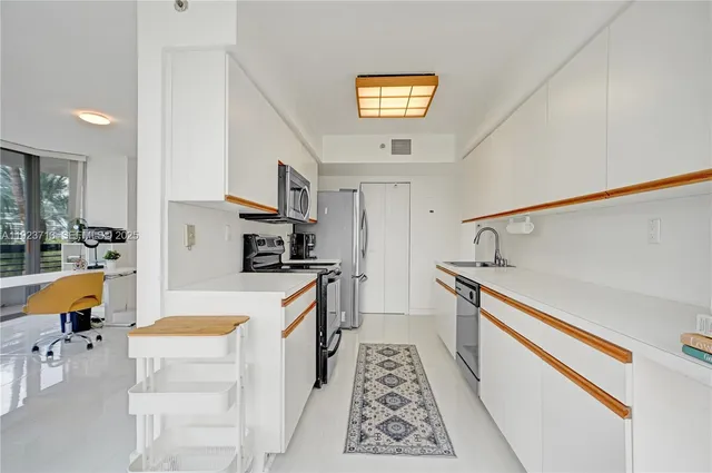 a kitchen with stainless steel appliances granite countertop a refrigerator and a stove top oven