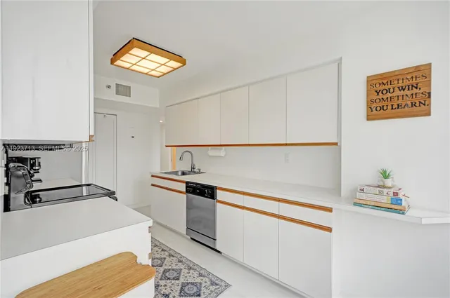 a kitchen with stainless steel appliances granite countertop a sink and a stove