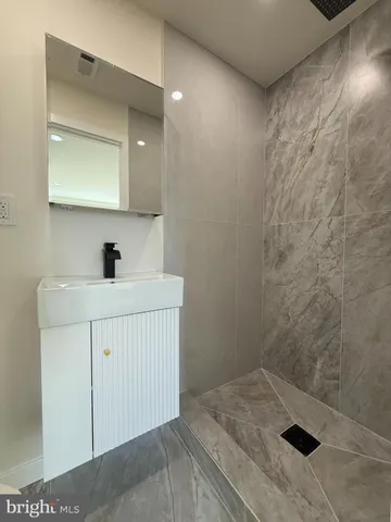 a bathroom with a sink a vanity and a mirror