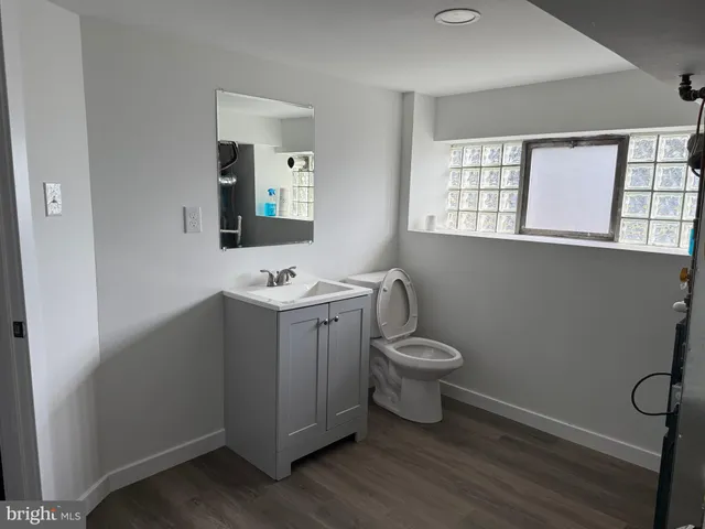 a bathroom with a toilet sink and mirror