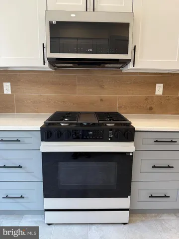 a kitchen with a stove and a microwave