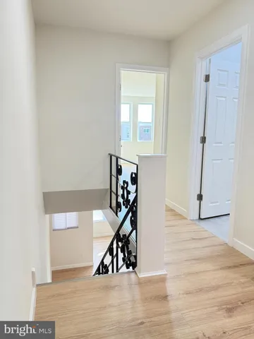 a view of a livingroom with wooden floor and stairs