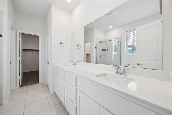 a spacious bathroom with a double vanity sink mirror and