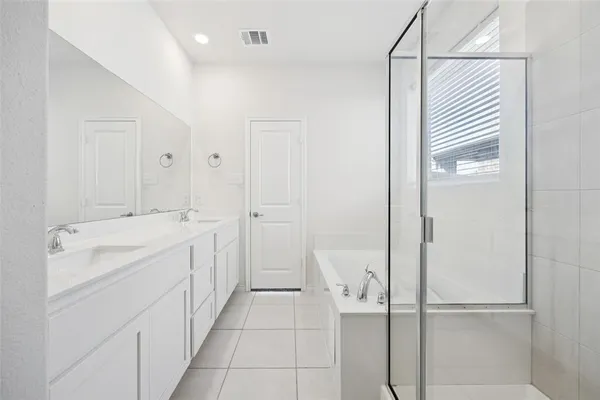 a spacious bathroom with a shower and a sink