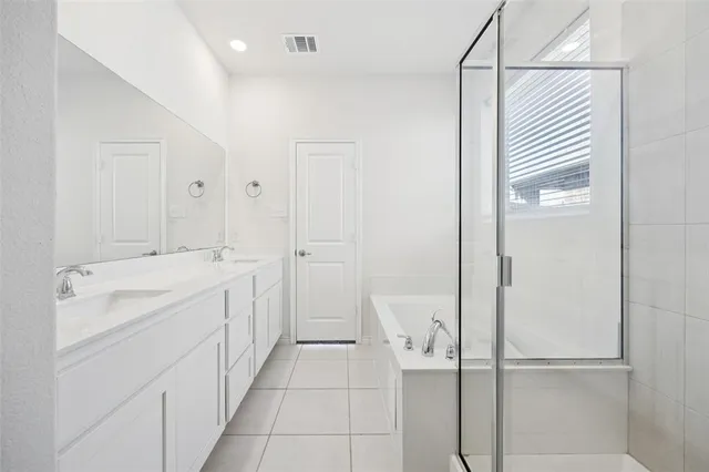a spacious bathroom with a shower and a sink