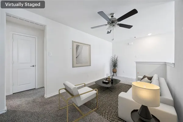 a work room with furniture and a ceiling fan