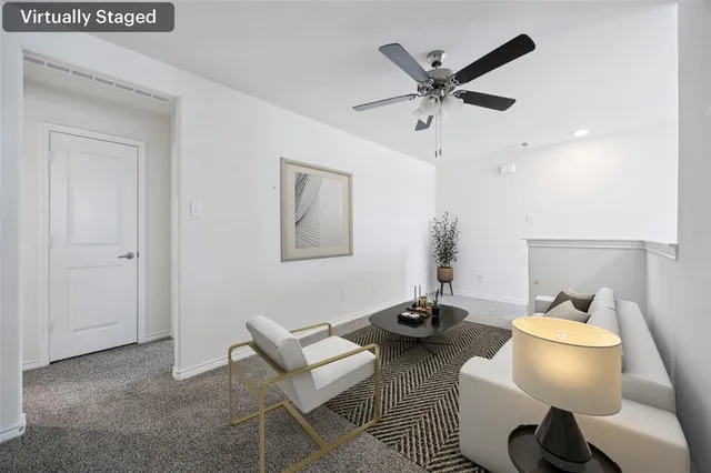 a work room with furniture and a ceiling fan