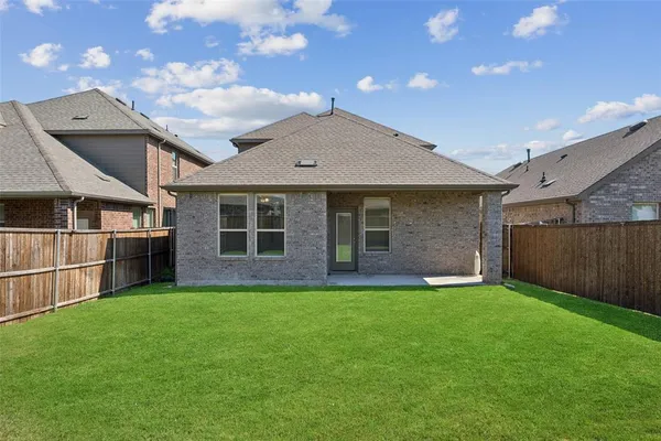 a view of a house with a yard and sitting area