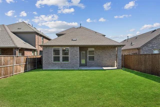 a view of a house with a yard and sitting area