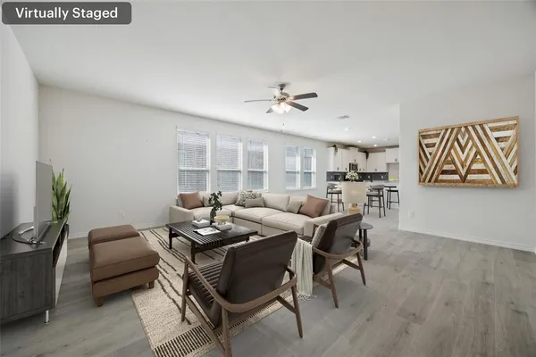 a living room with furniture and wooden floor