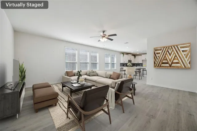 a living room with furniture and wooden floor