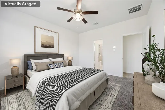 a bedroom with bed and a potted plant