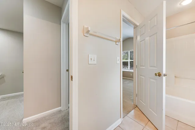 a bathroom with a shower and a glass door