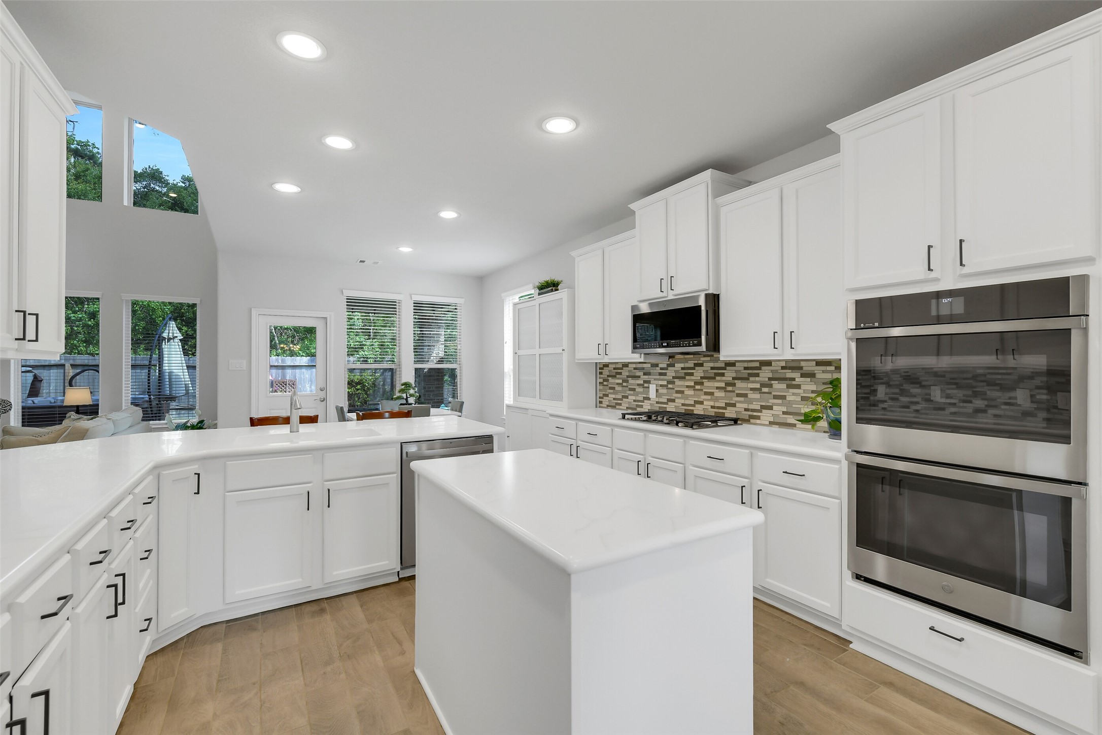 2803 Skerne Forest Dr Spring Spring, TX 77373 - Photo 10 of 44 a kitchen with granite countertop white cabinets and stainless steel appliances