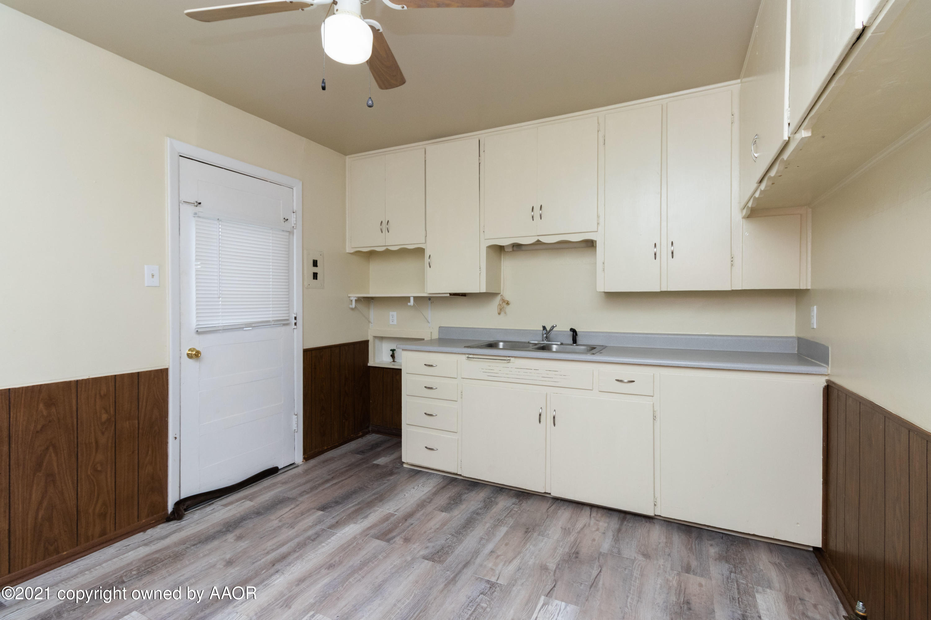 4629 South Lipscomb Street Amarillo, TX 79110 - Photo 5 of 12 a kitchen with granite countertop white cabinets and white appliances