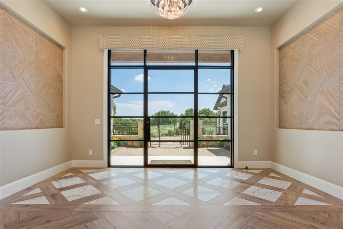 309 Highland Spring Lane Georgetown, TX 78633 - Photo 3 of 40 Majestic Foyer makes a statement with wood and marble tile patterned flooring. Glass doors are covered by Hunter Douglas Designer Screen Power View Shades...w/remote controls...