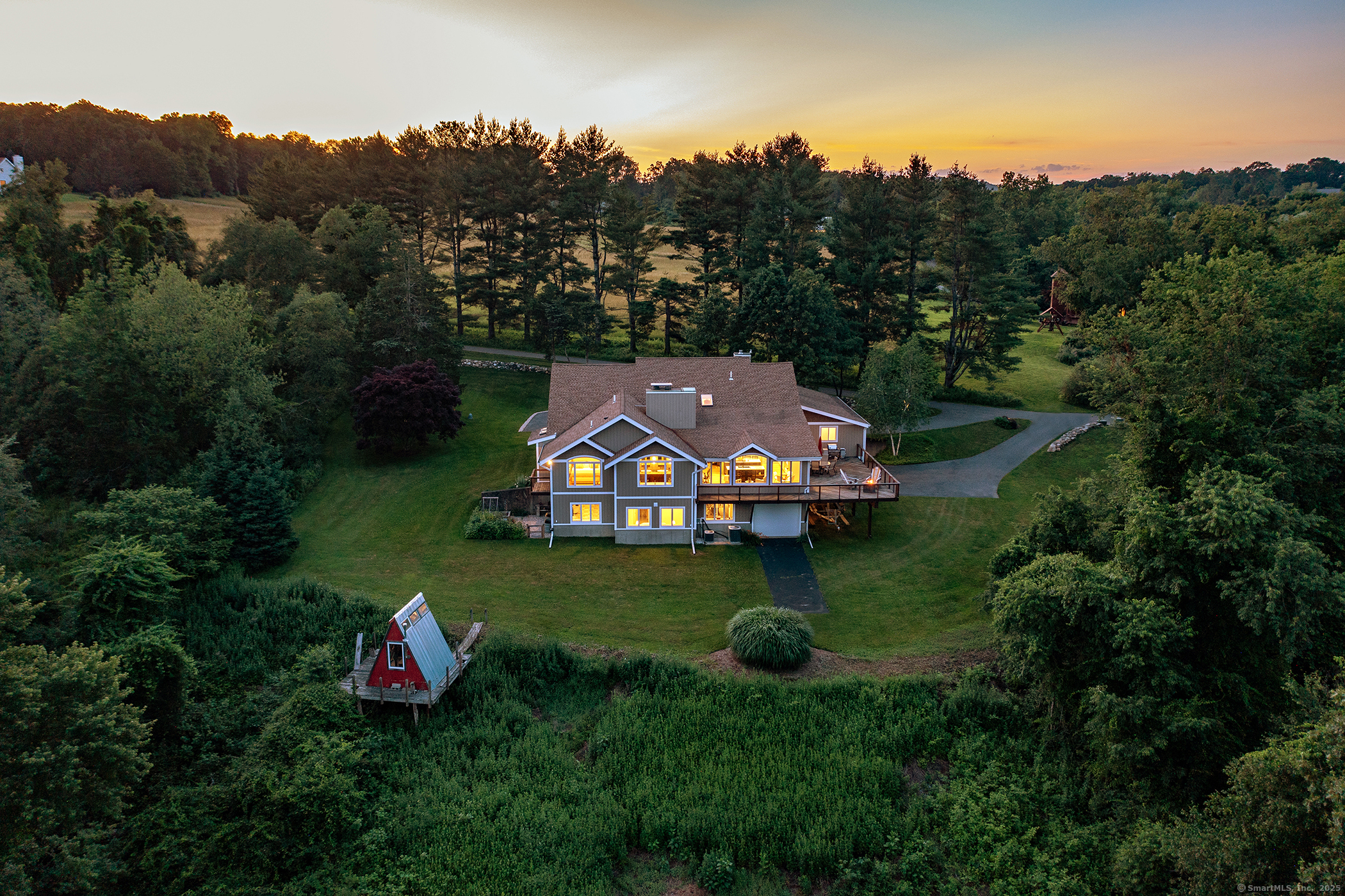 an aerial view of a house with outdoor space swimming pool