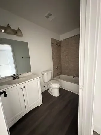 a bathroom with a toilet a sink and bathtub